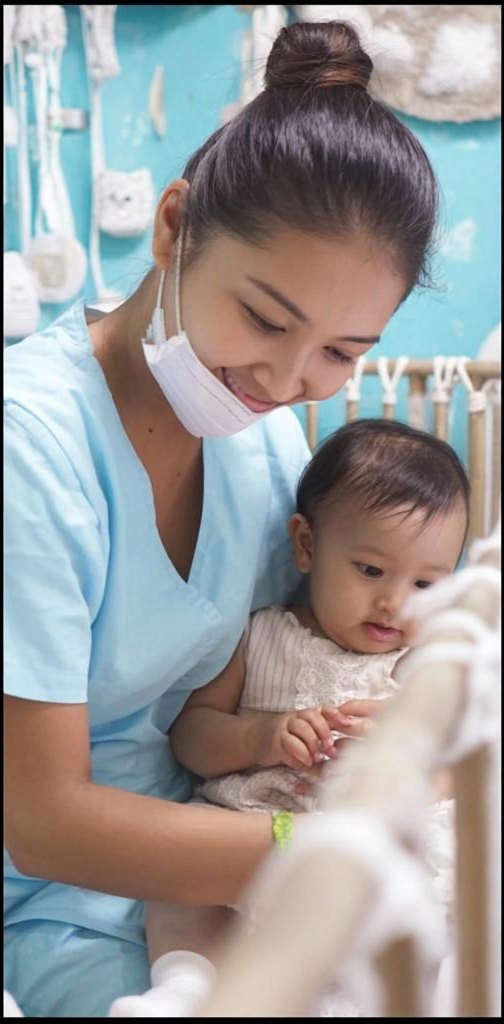 A caregiver holding an infant with clinical-grade attentiveness